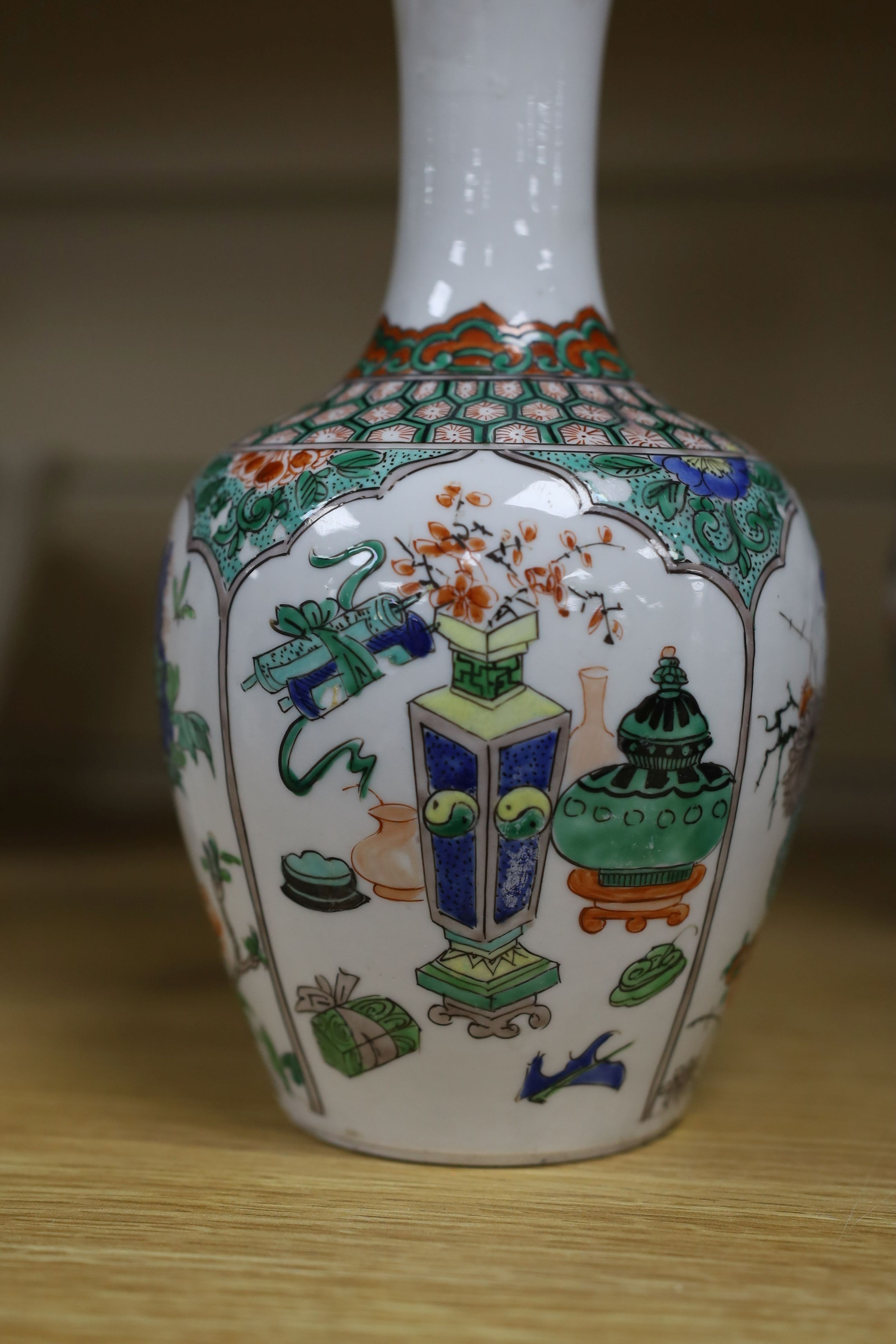 A pair Samson of Paris vases in the Chinese famille verte style and a Chinese Qianlong famille rose garlic neck vase with blue panelling motif, tallest 26cm